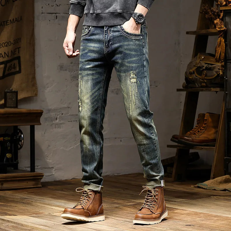 Men's skinny fit retro blue jeans with a zip fly closure laid flat.