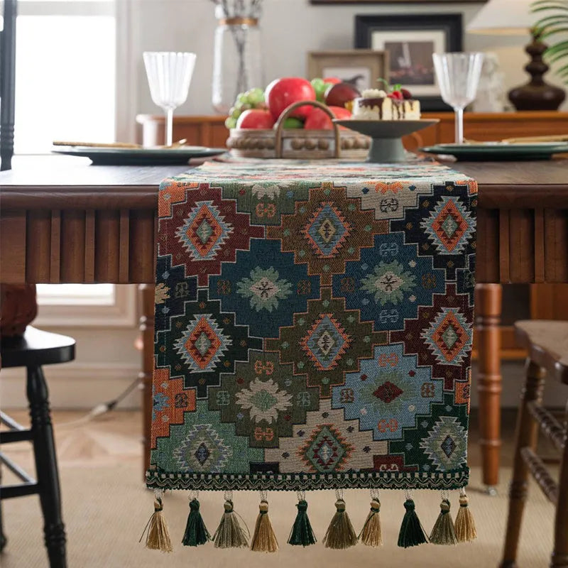 Nordic jacquard table runner with tassel trim in dark blue striped pattern laid on a wooden table.