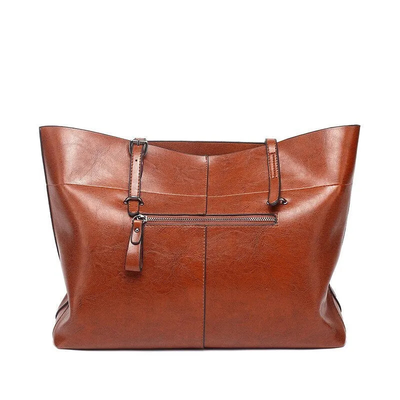 Brown waxed cowhide leather cross-body handbag showing two main compartments and a front mobile phone pocket.