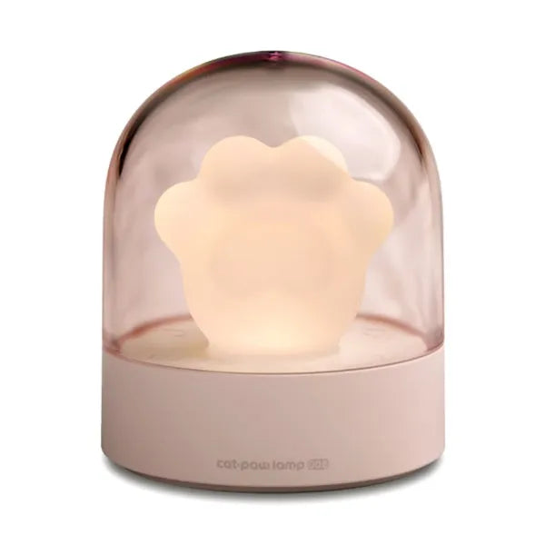 Grey cat paw shaped USB rechargeable night light and music box lamp on a desktop.