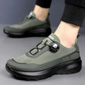 Men's black casual sneakers with a rotating button closure and thick platform sole.