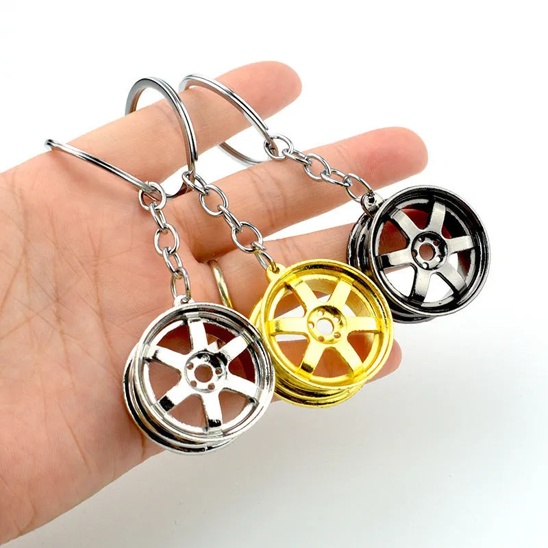 Zinc alloy wheel hub car keychain in gold, silver and gun black colour options