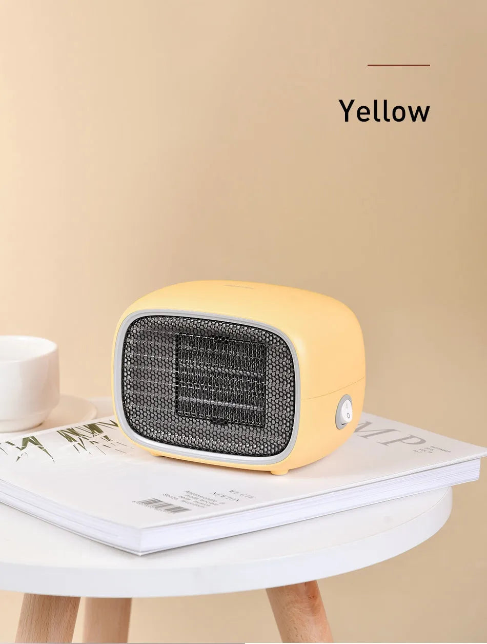 Green mini PTC ceramic fan heater showing compact size and metal mesh front grille.