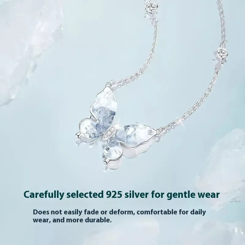 Close-up of a silver butterfly pendant necklace on an adjustable O-ring chain, showing detailed ice rain design.