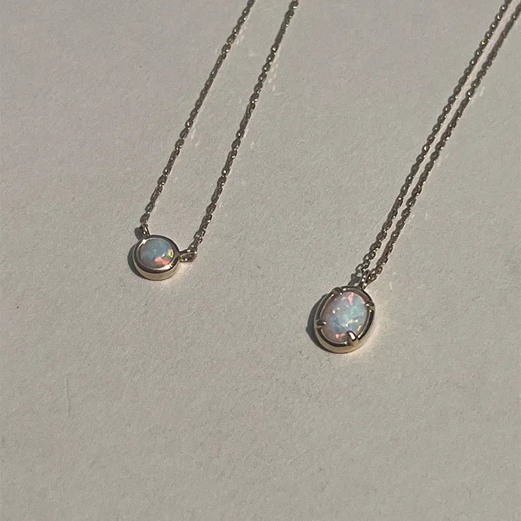 Geometric oval jelly opal pendant necklace on a chain in gold or silver tone.