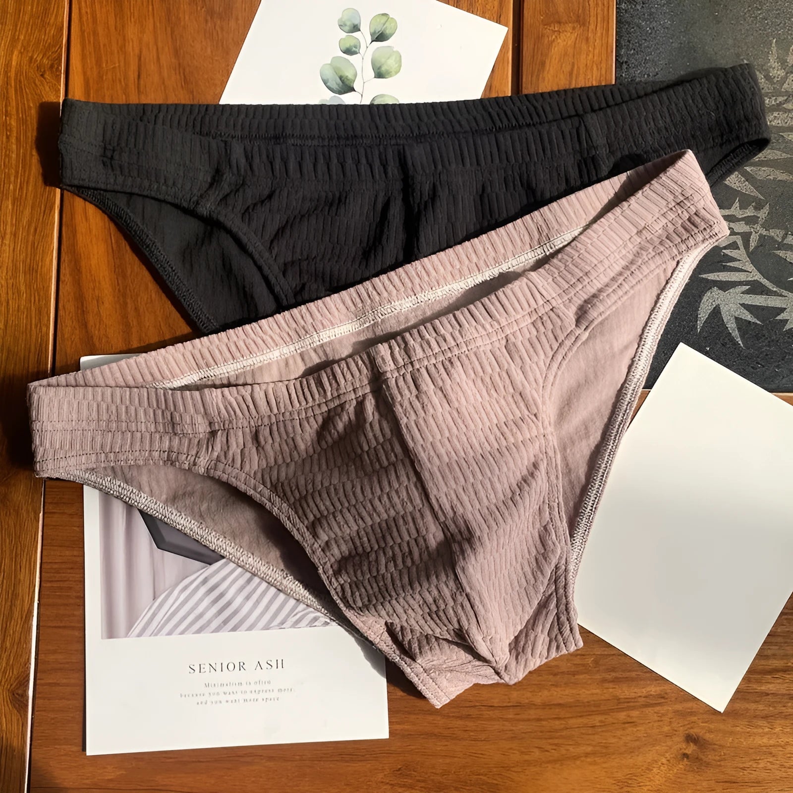 Men's solid colour cotton triangle briefs in apricot, shown from the front on a mid-waist fit model.