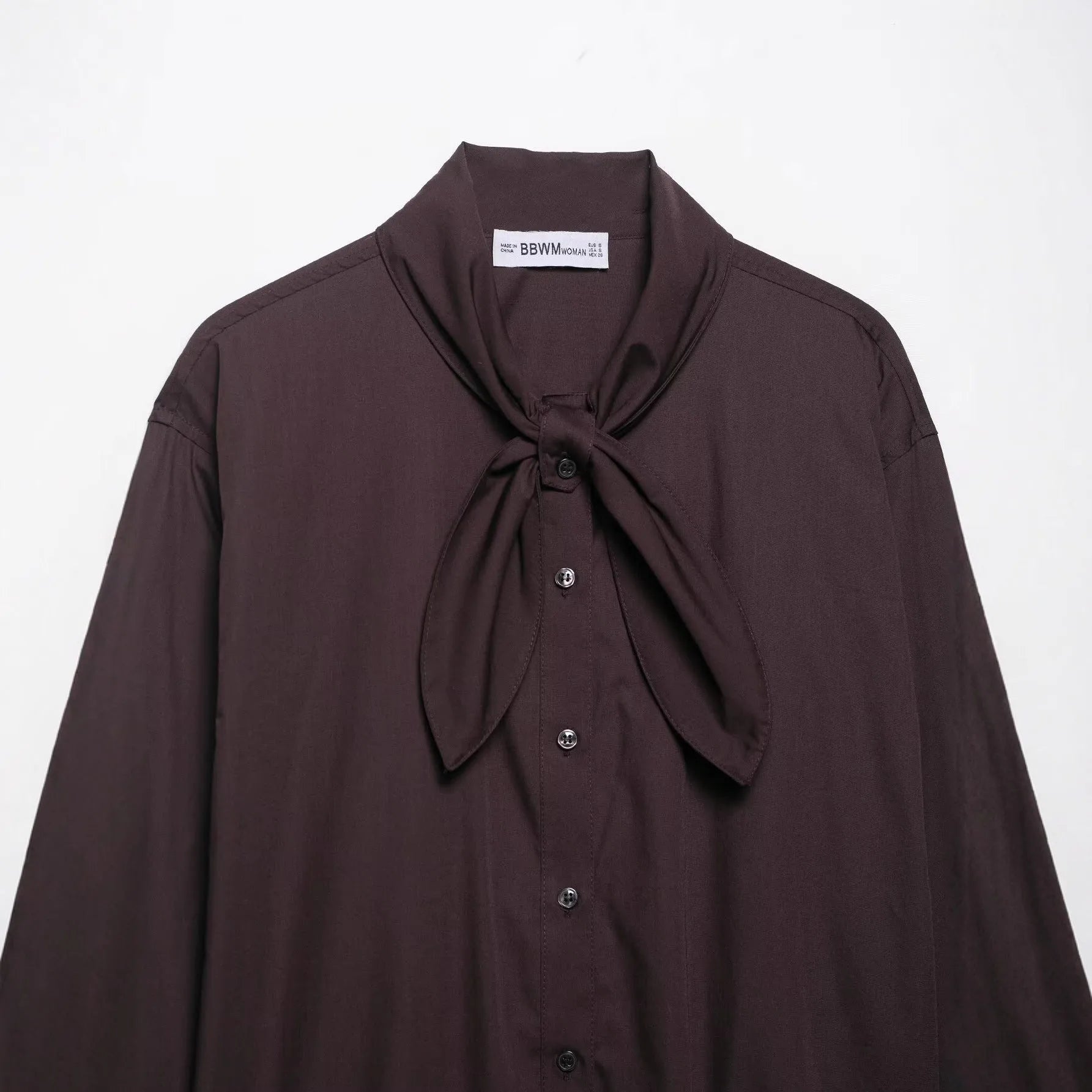 Brown loose-fit women's polyester poplin shirt with an attached bow tie, cardigan style.