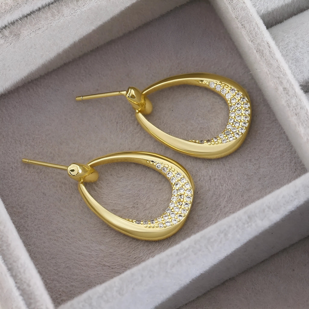 Women's geometric drop earrings with zircon details and yellow gold electroplated finish measuring 2.6 by 1.7 cm