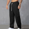 Men's corduroy cargo trousers in loose fit wide-leg design with elastic waist