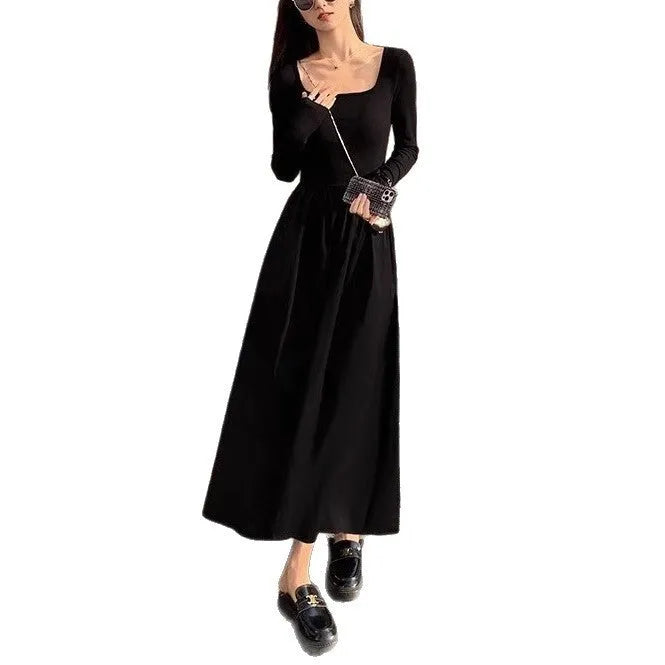 Women's black square collar knitted A-line dress with long sleeves on a hanger.