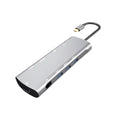 Grey aluminium USB-C docking station with HDMI, VGA, USB ports, and a short cable.