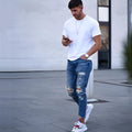 Men's deep blue distressed jeans with hole details on the legs.