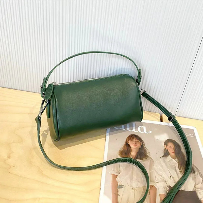 Soft brown genuine leather cylindrical crossbody phone bag with adjustable strap.