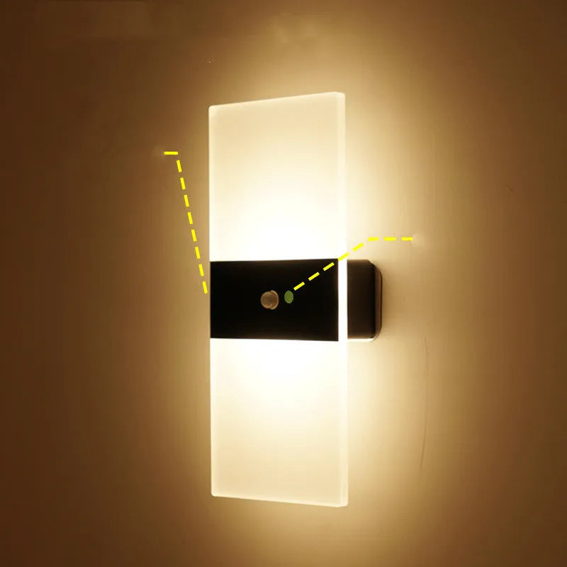 Magnetic rechargeable wall lamp in arc style, black finish, with warm light on a metal bedside shelf
