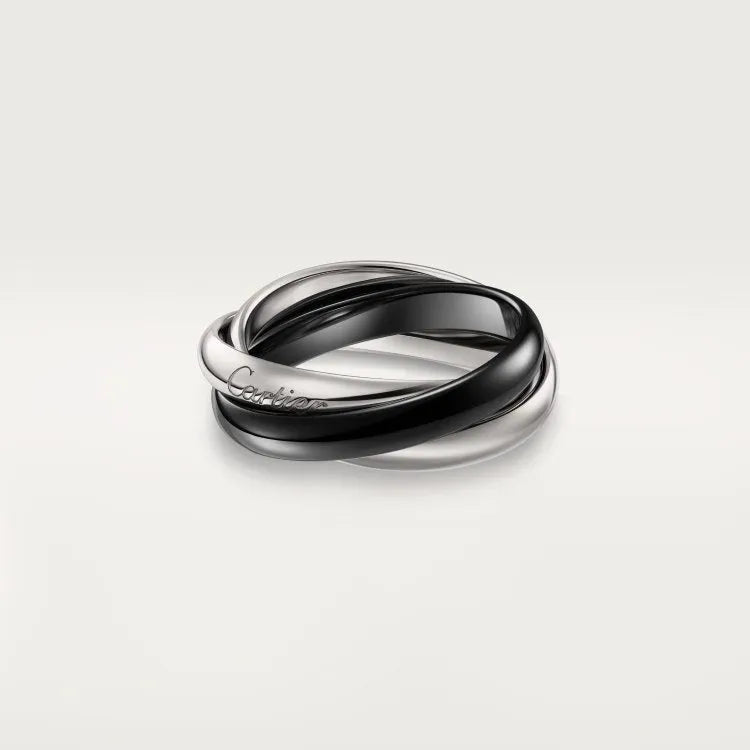 A silver couple ring with a full diamond band on a finger, showing geometric shape and personalised text engraving.