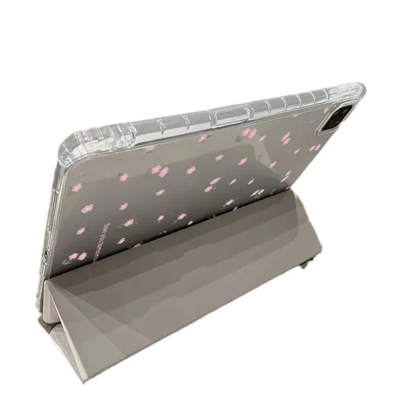 Clear iPad case with floral cartoon pattern, shown folded into a stand position.