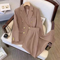 A loose-fit women's blouse in polyester fabric, shown in a neutral colour with a V-neck and regular sleeves.