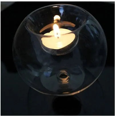 Hand-blown Europe style hollow glass candle holder in round design on table