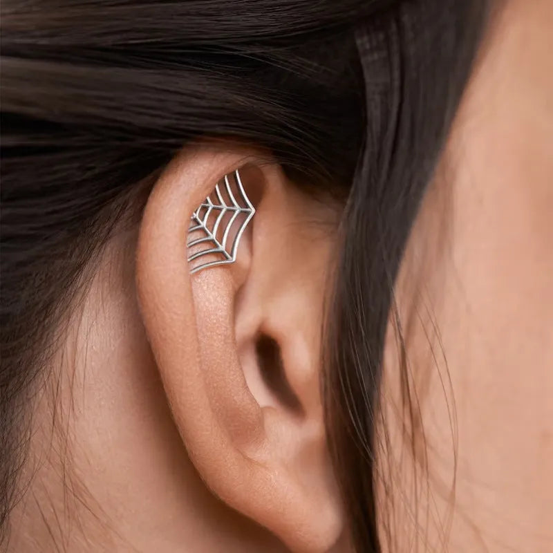 Geometric spider web stud earrings with electroplated gold and silver metallic finishes