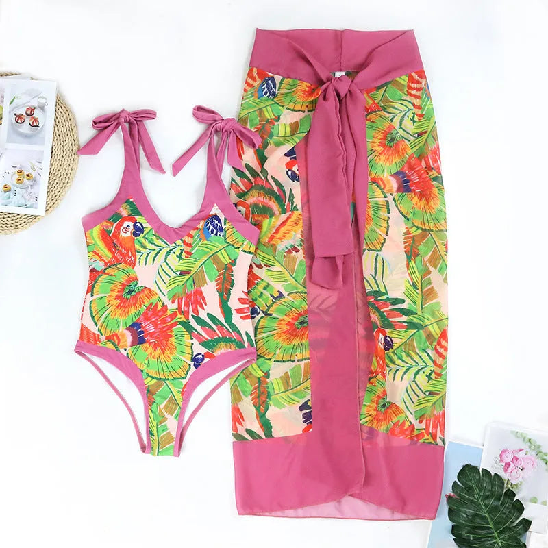 Pink floral print women's V-neck one-piece swimsuit with an attached skirt cover
