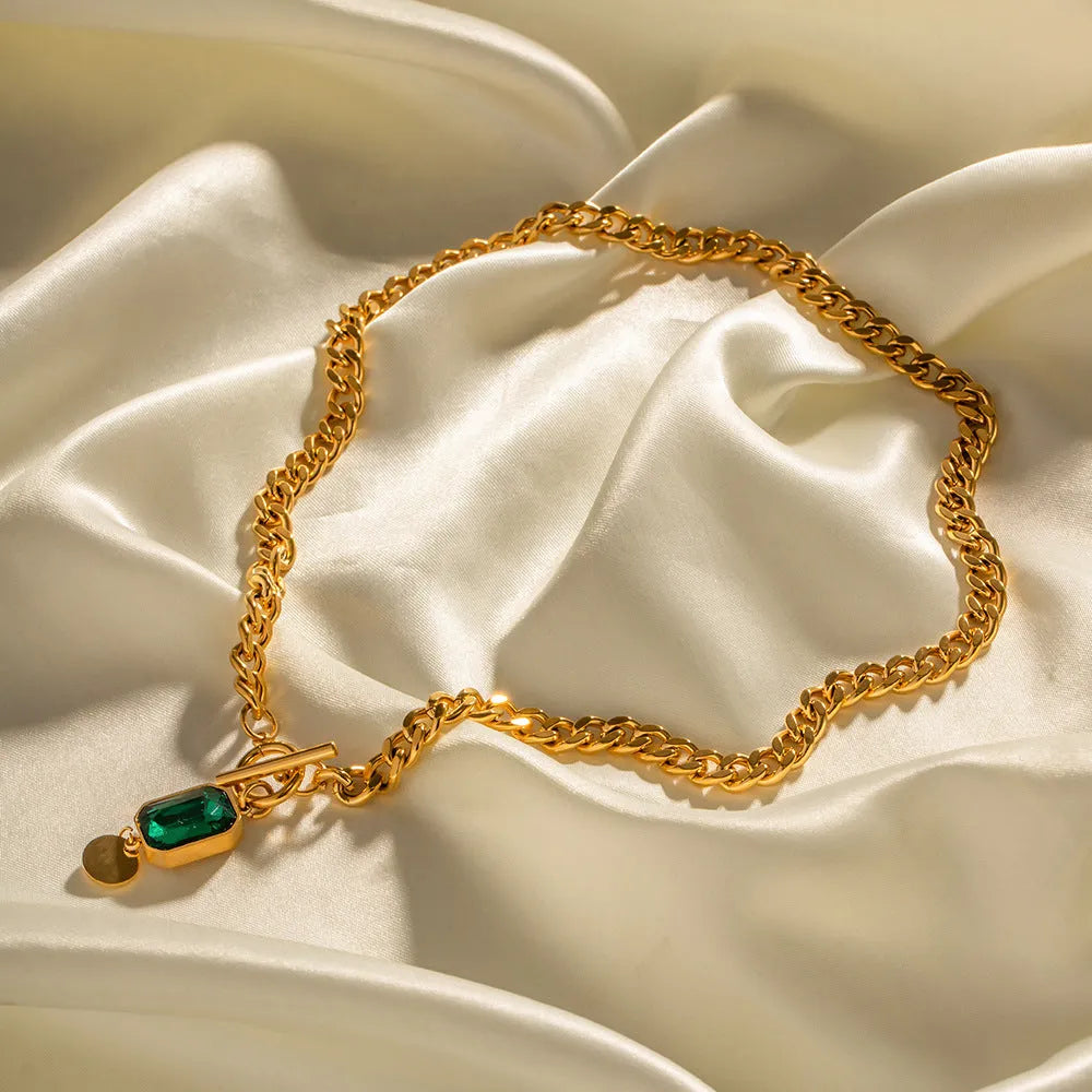 Gold electroplated pendant necklace with geometric round design on Cuban link chain