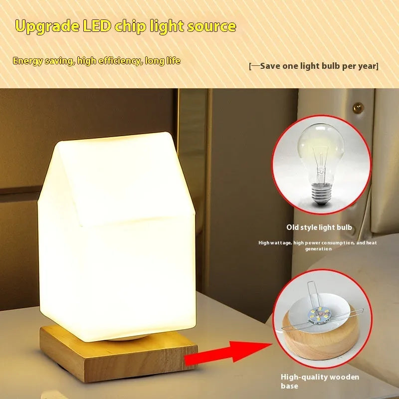 Nordic solid wood base USB table lamp with a white geometric shade on a wooden table.