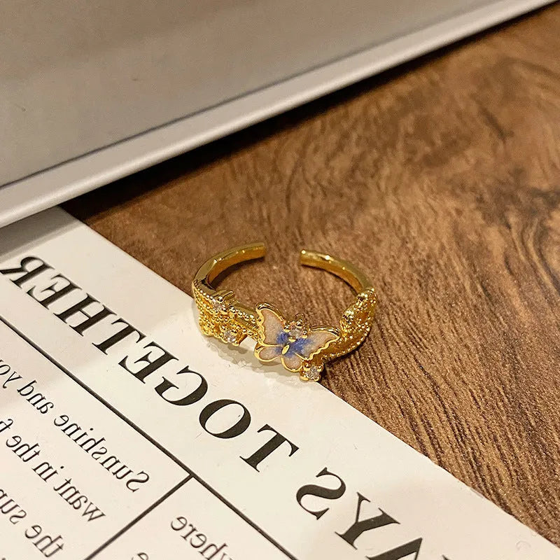 Copper butterfly women's ring with oil-drip finish showing open-loop design