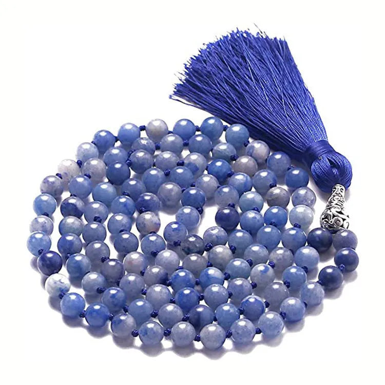 Long geometric agate and gemstone tassel necklace with blue, purple, and multi-coloured beads on a black background.