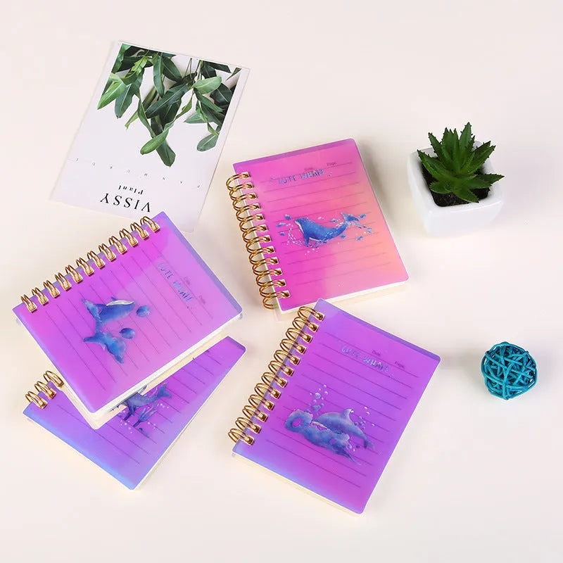 A7 spiral-bound notebook with a PP plastic cover in one of four colour options, showing the spiral binding and compact size.