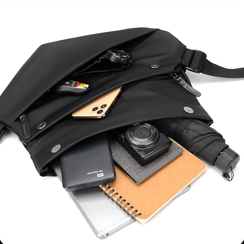 Grey PU leather men's crossbody bag with a shoulder strap, shown with open compartment for phone and documents.