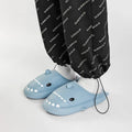 Winter soft bottom household couple EVA cartoon shark cotton slippers in blue, grey, pink on a floor