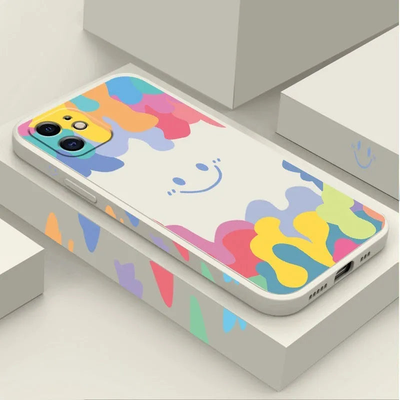 White silicone iPhone case with rainbow smiley face design and attached lanyard