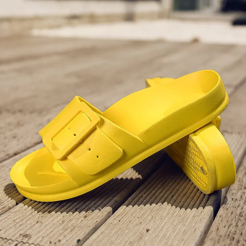 Women's grey blue buckle flip flops with a soft EVA sole on a plain background