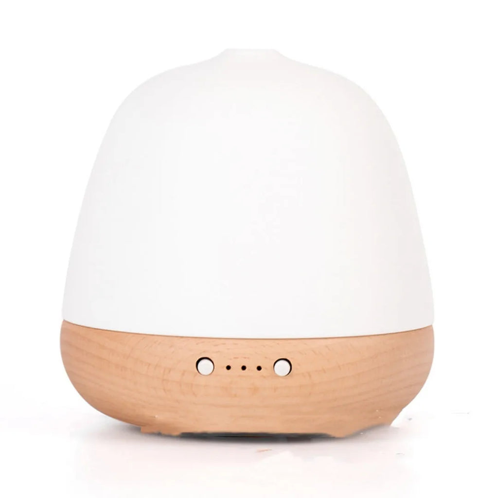 White ceramic ultrasonic essential oil humidifier with 180ml capacity on a table top