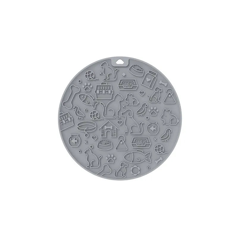 Round grey silicone pet lick mat with textured surface and a clear suction cup on its base.