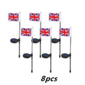 White solar-powered garden flag light showing American flag design on stainless steel pole.