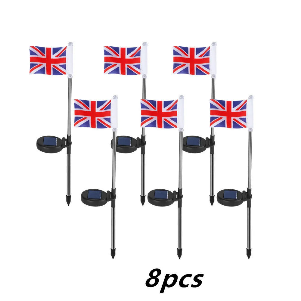 White solar-powered garden flag light showing American flag design on stainless steel pole.