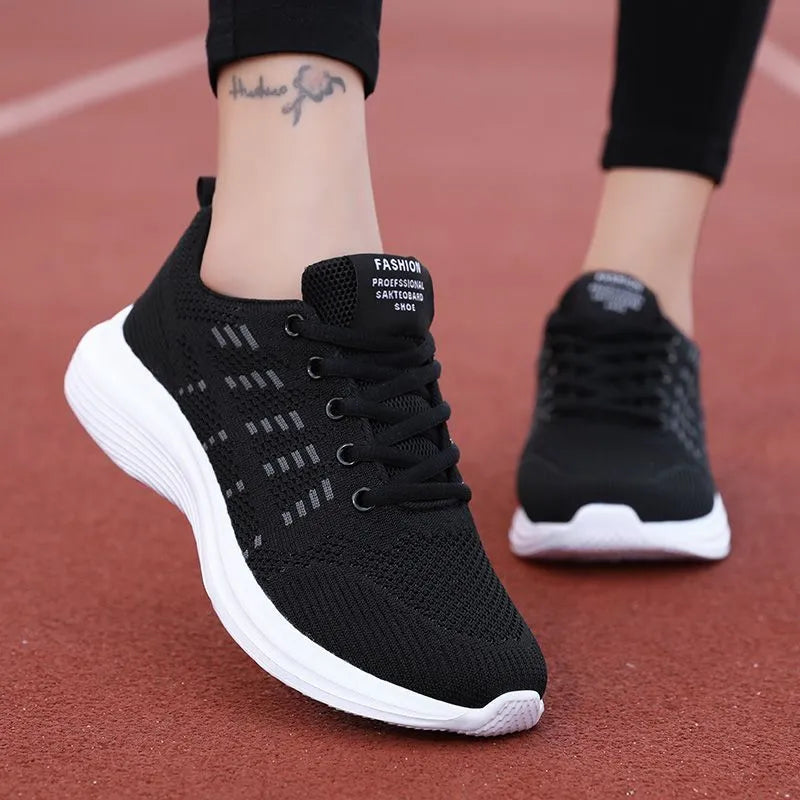 Women's black mesh breathable non-slip sneaker with lace-up front and flat heel, side view