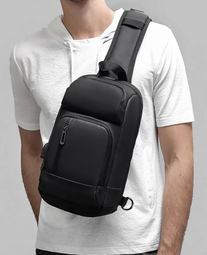 Black PVC outdoor leisure shoulder bag showing air cushion strap and organisational pockets
