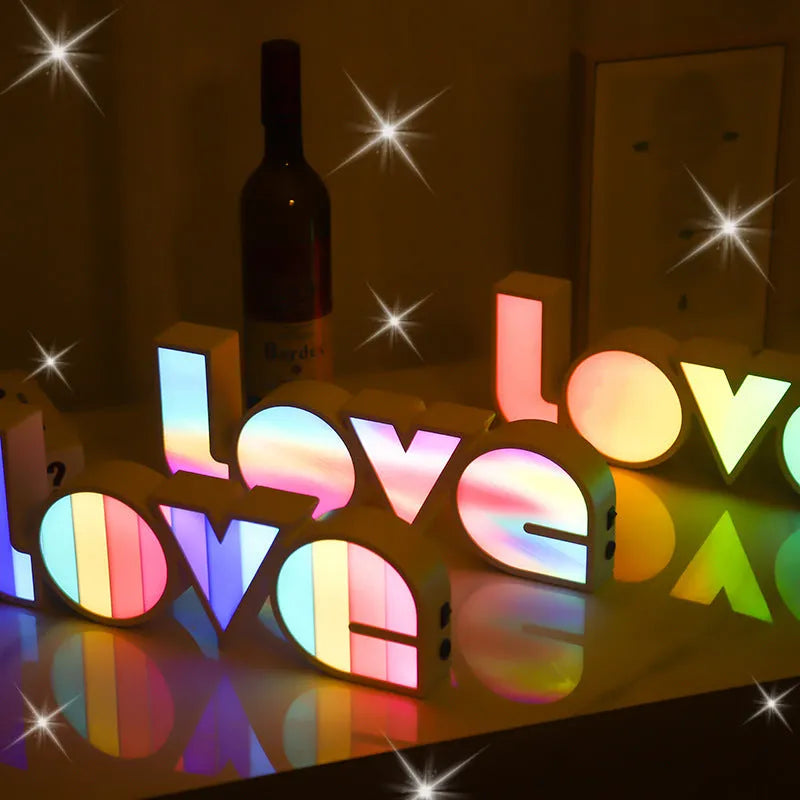 LED decorative light with rainbow-coloured LOVE word on plastic shade
