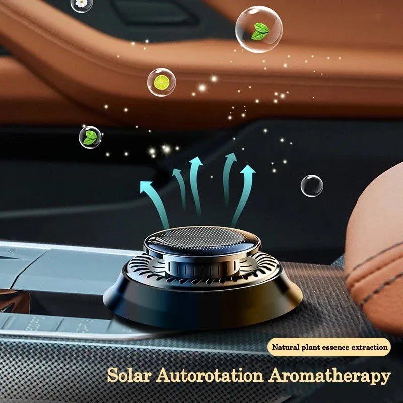 Solar powered kinetic car air freshener with rotating double rings on black plastic base