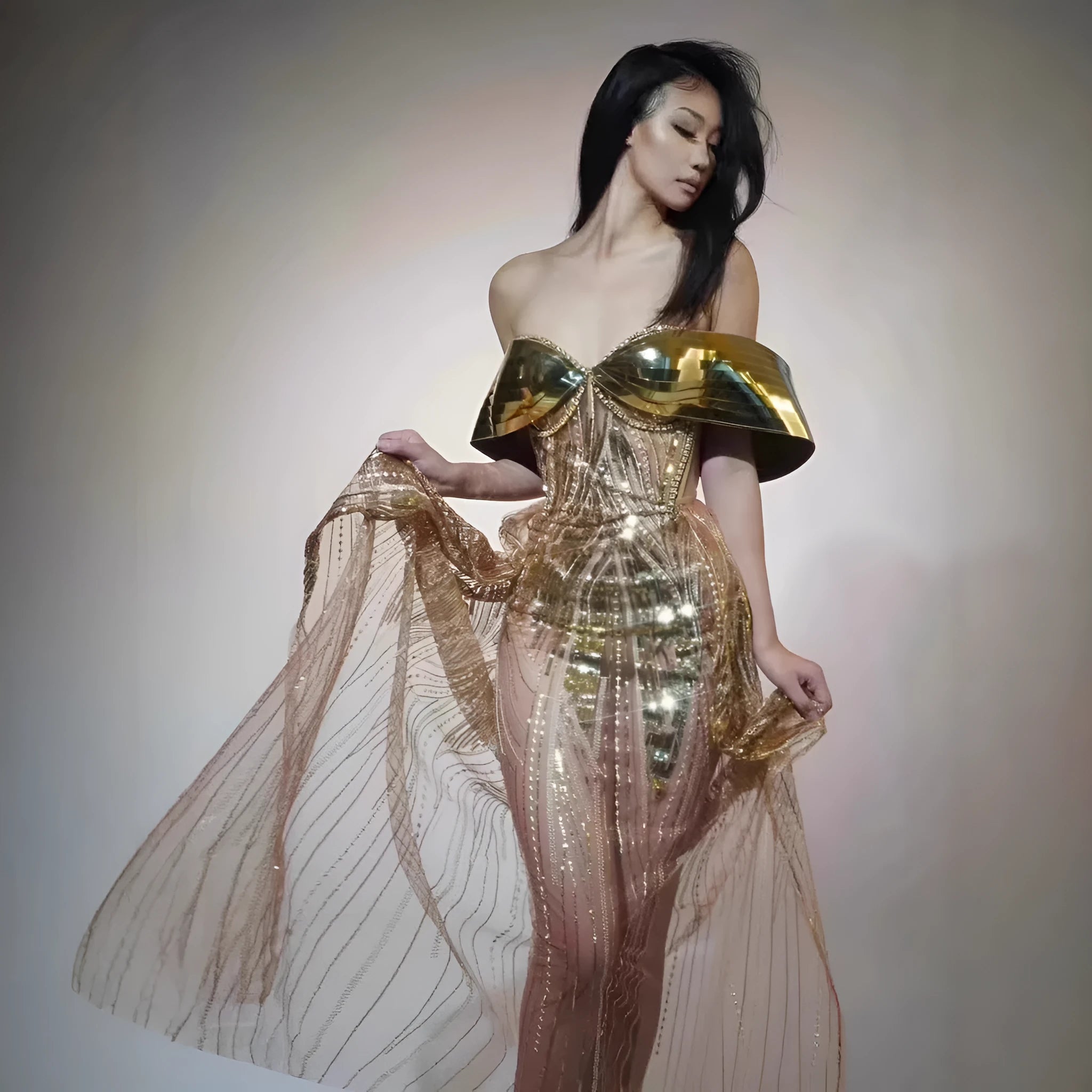 Gold strapless long dress with sequined tulle skirt and high side split, worn as formal evening wear.