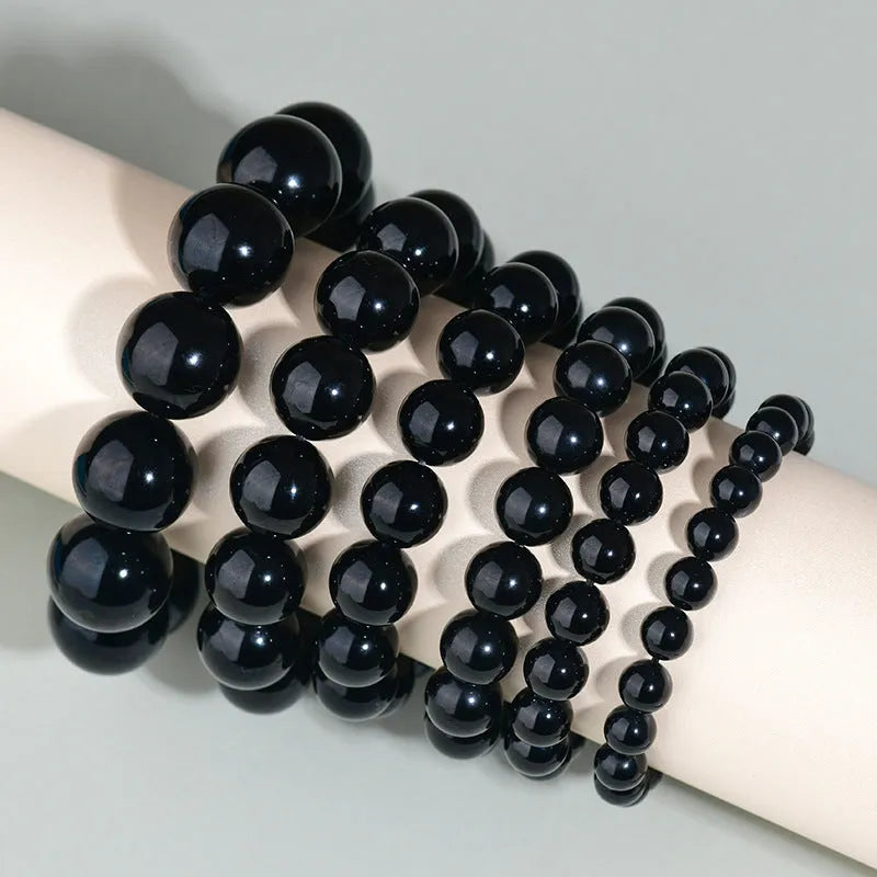 Hand-woven obsidian couple bracelet with year of birth symbols in ethnic style design