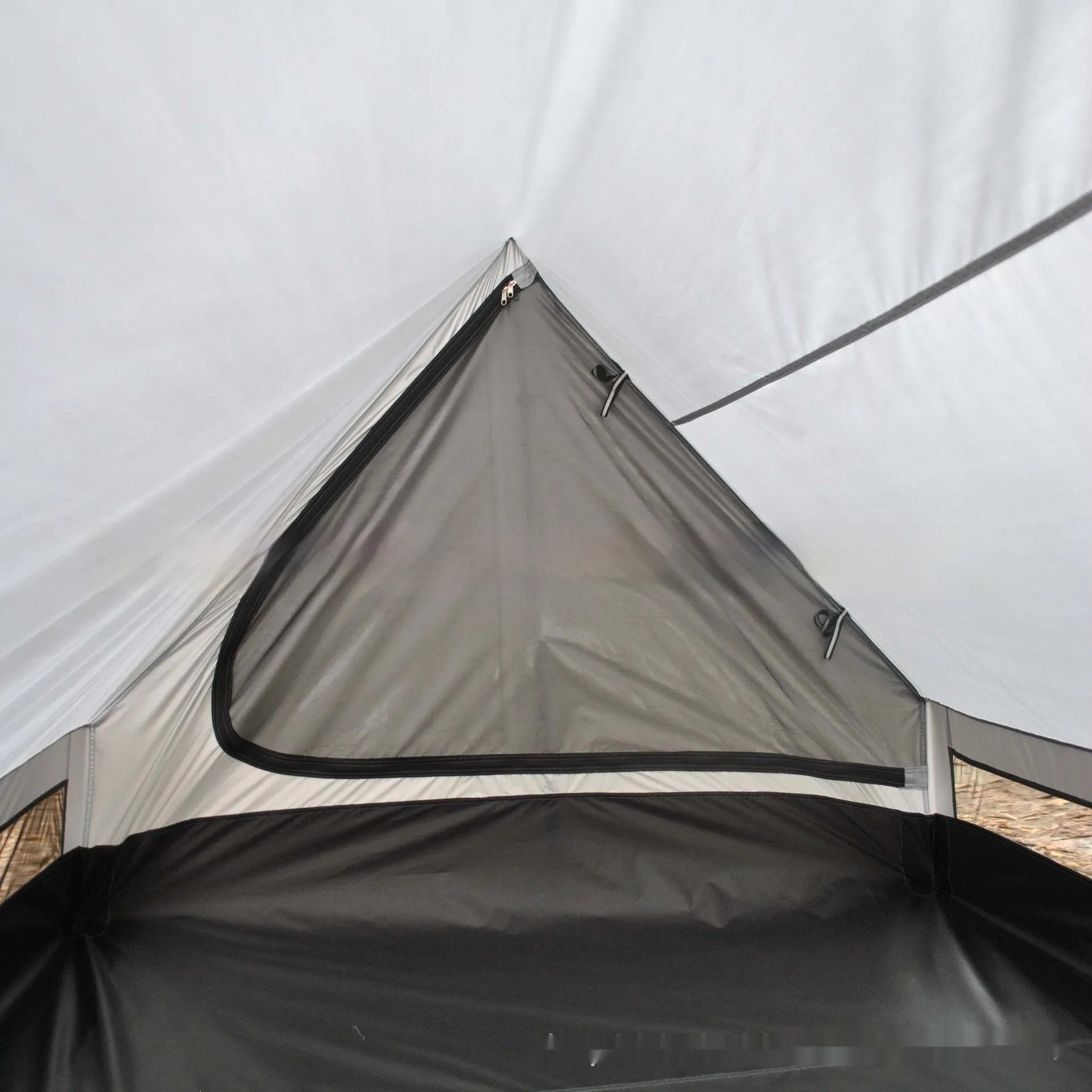 Brown or white A-line pole-free cabin tent for hiking, shown packed and pitched.
