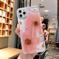 Pink and yellow floral print TPU back cover case for iPhone on a white background.
