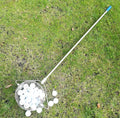 Metallic coloured stainless steel golf ball picker tool on a driving range turf.