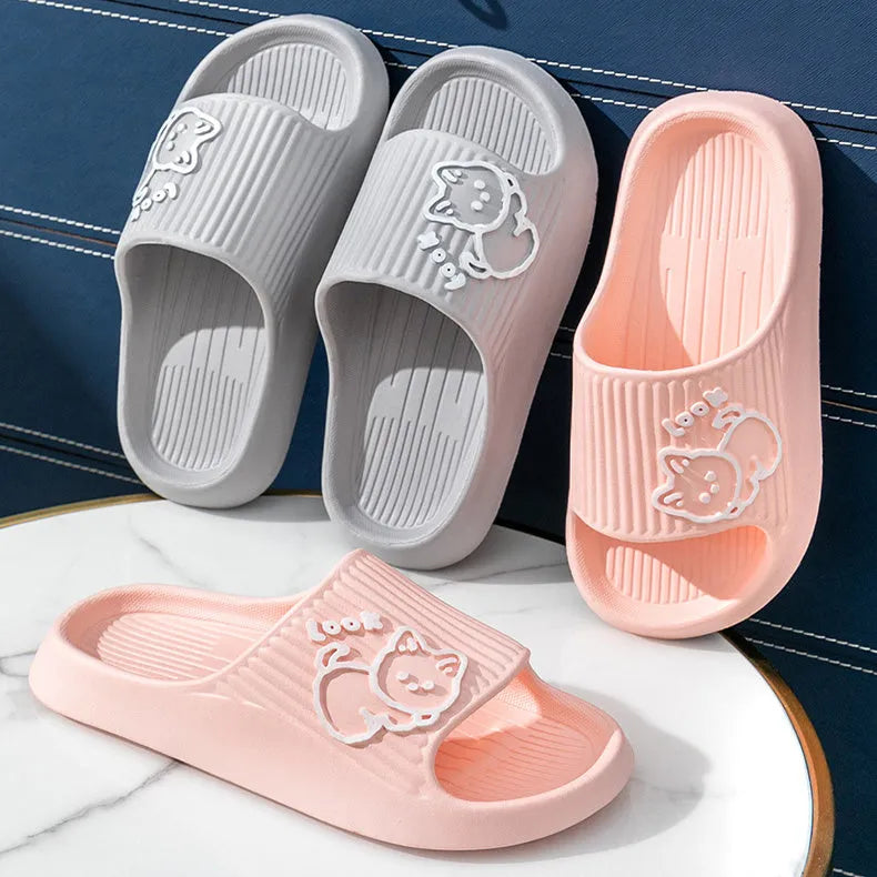 Women's pink cat-themed flip-flop slippers with a thick light blue EVA platform sole.