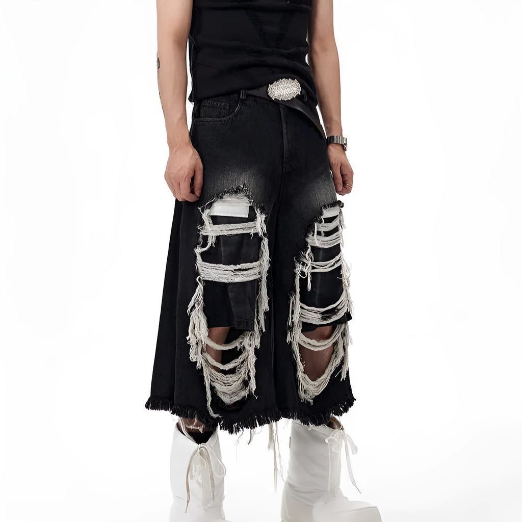 Woman wearing black cropped wide-leg jeans with a mid-high waist and ripped patchwork details