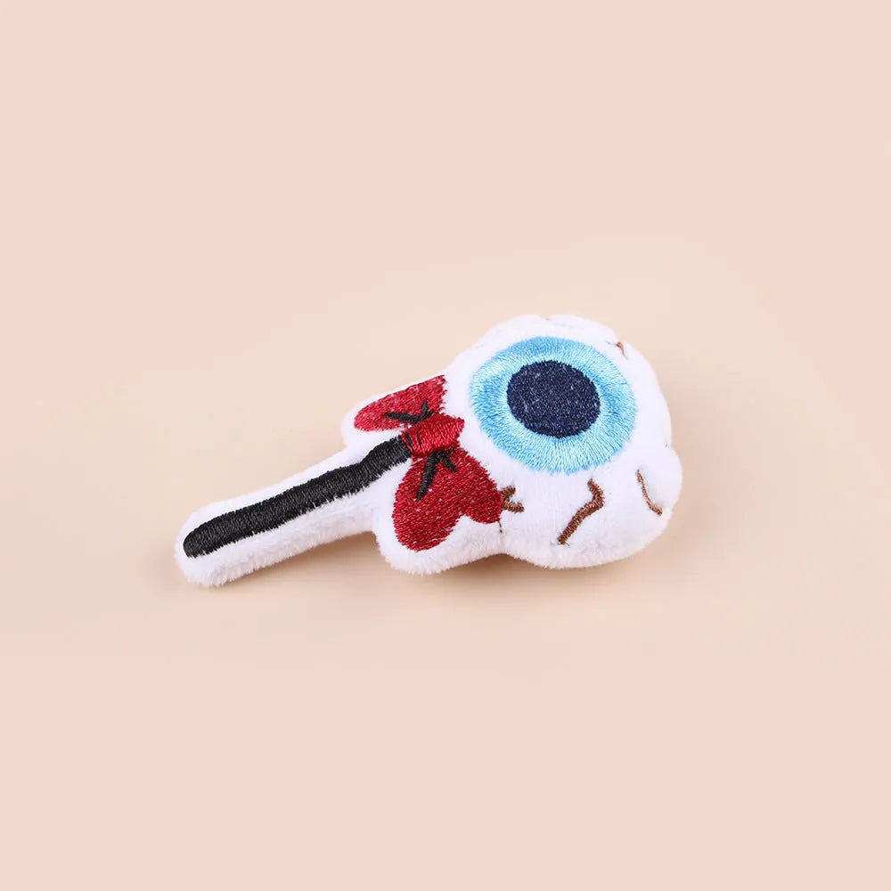 Small cat teaser wand with dangling plush candy, eye, and skull toy attachments