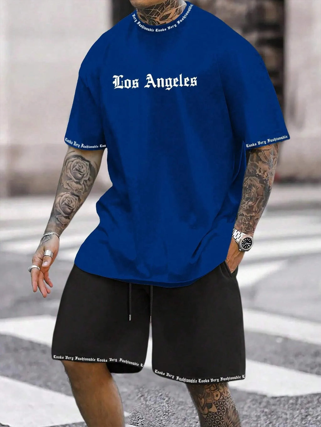 Men's grey sports short sleeve top and matching shorts set on hanger